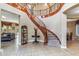 Elegant foyer with a grand curved staircase and tile flooring at 3713 E Cat Balue Dr, Phoenix, AZ 85050