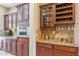 Kitchen featuring custom cabinets, granite counters, and a wine rack at 3713 E Cat Balue Dr, Phoenix, AZ 85050
