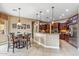 Well-lit kitchen with a large island, stainless steel appliances, and an adjacent dining area at 3713 E Cat Balue Dr, Phoenix, AZ 85050
