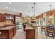 Open kitchen featuring granite countertops, stainless steel appliances, and a center island at 3713 E Cat Balue Dr, Phoenix, AZ 85050