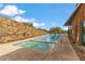 Community lap pool with a brick wall and tanning ledge by the building at 3713 E Cat Balue Dr, Phoenix, AZ 85050