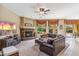 Cozy living room with a fireplace, leather seating, and views of the outdoor area at 3713 E Cat Balue Dr, Phoenix, AZ 85050