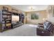 Spacious living room with large built-in shelving, a plush sofa, and a large window at 3713 E Cat Balue Dr, Phoenix, AZ 85050