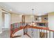 Loft area with wooden banisters and stairs showcasing a game table with chairs at 3713 E Cat Balue Dr, Phoenix, AZ 85050