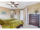 Comfortable main bedroom featuring a ceiling fan, neutral walls, and an open closet door at 3713 E Cat Balue Dr, Phoenix, AZ 85050