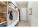 Mudroom with custom shelving, a bench, hooks for coats, and access to the garage at 3713 E Cat Balue Dr, Phoenix, AZ 85050
