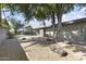 Landscaped backyard with decorative gravel, mature trees, and hardscape at 4001 E Cannon Dr, Phoenix, AZ 85028