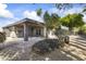 Backyard with desert landscaping, including gravel, low lying shrubs, and a covered patio at 4001 E Cannon Dr, Phoenix, AZ 85028