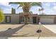 Charming single-story home with a desert landscape, palm tree, and a well-maintained front yard at 4001 E Cannon Dr, Phoenix, AZ 85028