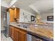 Kitchen area showcasing stainless steel appliances, a stainless steel sink, and custom wood cabinets at 4001 E Cannon Dr, Phoenix, AZ 85028