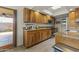Well-equipped kitchen featuring wood cabinetry, granite counters, and stainless steel appliances at 4001 E Cannon Dr, Phoenix, AZ 85028