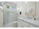 Bright bathroom featuring a glass-enclosed shower, modern vanity, and stylish mirror at 4216 N 42Nd St, Phoenix, AZ 85018