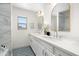 Elegant bathroom featuring a double vanity, patterned tile floor, and a window for natural light at 4216 N 42Nd St, Phoenix, AZ 85018