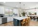 Modern kitchen featuring a large island with seating, pendant lighting, and stainless steel appliances at 4216 N 42Nd St, Phoenix, AZ 85018