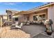 Inviting back patio features a comfortable seating area, awning and an outdoor kitchen at 42186 W Cribbage Rd, Maricopa, AZ 85138