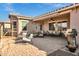 Inviting back patio features a comfortable seating area, awning and an outdoor kitchen at 42186 W Cribbage Rd, Maricopa, AZ 85138