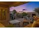 Inviting back patio featuring a built-in fireplace, comfortable seating, and outdoor kitchen area at 42186 W Cribbage Rd, Maricopa, AZ 85138