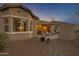 Charming backyard featuring a covered patio, desert landscaping, and a cozy seating area, perfect for relaxation at 42186 W Cribbage Rd, Maricopa, AZ 85138