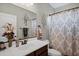 Bathroom with decorative mirror and curtain, a single sink with wood vanity and a toilet at 42186 W Cribbage Rd, Maricopa, AZ 85138