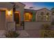 Close up of a charming tan home with decorative front door and cozy porch at 42186 W Cribbage Rd, Maricopa, AZ 85138