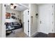 Open entryway leading to a living area with a gray sofa and decorative wall hangings at 42186 W Cribbage Rd, Maricopa, AZ 85138