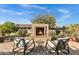 Cozy outdoor fireplace with comfortable seating, perfect for enjoying evenings in the backyard at 42186 W Cribbage Rd, Maricopa, AZ 85138