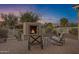 Cozy outdoor fireplace with comfortable seating, perfect for enjoying evenings in the backyard at 42186 W Cribbage Rd, Maricopa, AZ 85138