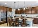 Beautiful kitchen with stainless steel appliances, granite countertops and dark wood cabinets at 42186 W Cribbage Rd, Maricopa, AZ 85138