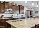 Close up of a kitchen island with granite countertops and stainless steel sink at 42186 W Cribbage Rd, Maricopa, AZ 85138