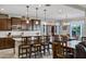 Spacious kitchen with dark wood cabinetry, a granite countertop island and stainless steel appliances at 42186 W Cribbage Rd, Maricopa, AZ 85138