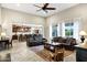 Spacious living room featuring tile floors, high ceilings, and an open kitchen at 42186 W Cribbage Rd, Maricopa, AZ 85138