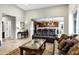 Inviting living room with leather couches and a view into the modern kitchen with wood cabinets at 42186 W Cribbage Rd, Maricopa, AZ 85138