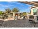 Outdoor patio with fireplace, lounge chairs, lush landscaping, and paver flooring at 42186 W Cribbage Rd, Maricopa, AZ 85138