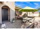 Inviting patio with a dining table set and umbrella, perfect for outdoor relaxation at 42186 W Cribbage Rd, Maricopa, AZ 85138