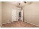 Bedroom with tile flooring, neutral paint, and closet with doors open to show interior at 43298 W Delia Blvd, Maricopa, AZ 85138