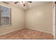 Bedroom featuring a ceiling fan, and large window with blinds for natural light at 43298 W Delia Blvd, Maricopa, AZ 85138