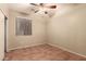Bedroom with ceiling fan, window, closet and tile floors throughout at 43298 W Delia Blvd, Maricopa, AZ 85138