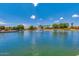 Community pond with fountain and manicured landscaping offers a serene escape at 43298 W Delia Blvd, Maricopa, AZ 85138