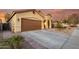 Inviting home exterior featuring desert landscaping, concrete driveway, and a well-kept lawn at 43298 W Delia Blvd, Maricopa, AZ 85138