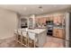 The open concept kitchen has a central island with barstool seating and ample counter space at 43298 W Delia Blvd, Maricopa, AZ 85138