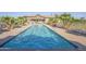 Long, inviting lap pool offers a refreshing way to exercise and enjoy the outdoors in a serene setting at 43298 W Delia Blvd, Maricopa, AZ 85138