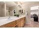 Double sink vanity, white counters, and decorative lighting in the main bathroom at 43298 W Delia Blvd, Maricopa, AZ 85138