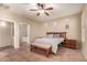 Main bedroom offers natural light, tile floors, and ceiling fan; ensuite bathroom is visible at 43298 W Delia Blvd, Maricopa, AZ 85138