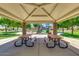Covered picnic area with stone pillars, picnic tables and an expansive view of the playground in the community at 43298 W Delia Blvd, Maricopa, AZ 85138
