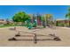 Colorful playground with slides, climbing structures, and seesaws in the Villages at Rancho El Dorado at 43298 W Delia Blvd, Maricopa, AZ 85138