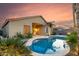Backyard pool with desert landscaping offers a relaxing retreat with evening light at 43298 W Delia Blvd, Maricopa, AZ 85138
