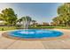 Community splash pad with spraying water features surrounded by green grass and mature landscaping at 43298 W Delia Blvd, Maricopa, AZ 85138