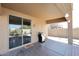 Covered patio with a stainless steel barbecue grill, and a sliding glass door leading inside at 45558 W Mountain View Rd, Maricopa, AZ 85139