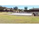Outdoor basketball court in community with trees and grass and surrounding homes on a sunny day at 45558 W Mountain View Rd, Maricopa, AZ 85139