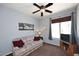 Comfortable bedroom with a cozy sofa, a window that allows natural light to enter, and a ceiling fan at 45558 W Mountain View Rd, Maricopa, AZ 85139